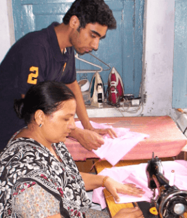 A rural woman stitching the salwar-kameez part of the school uniform